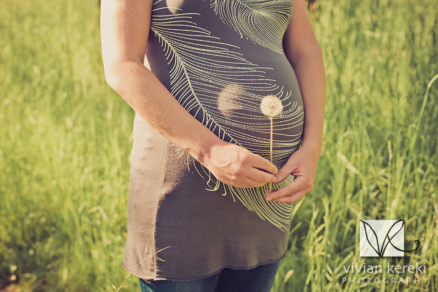 pregnant woman in grassy field black and white